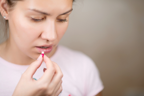 woman taking a pill