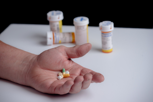 person holding pills in their hand