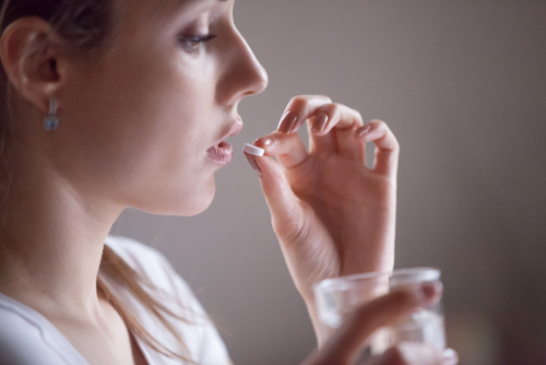 woman taking pill