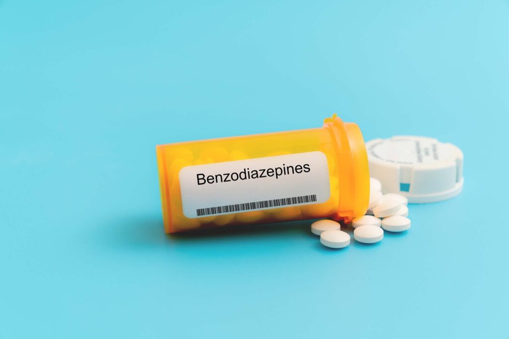 picture of pill bottle labeled benzodiazepines with a light blue background