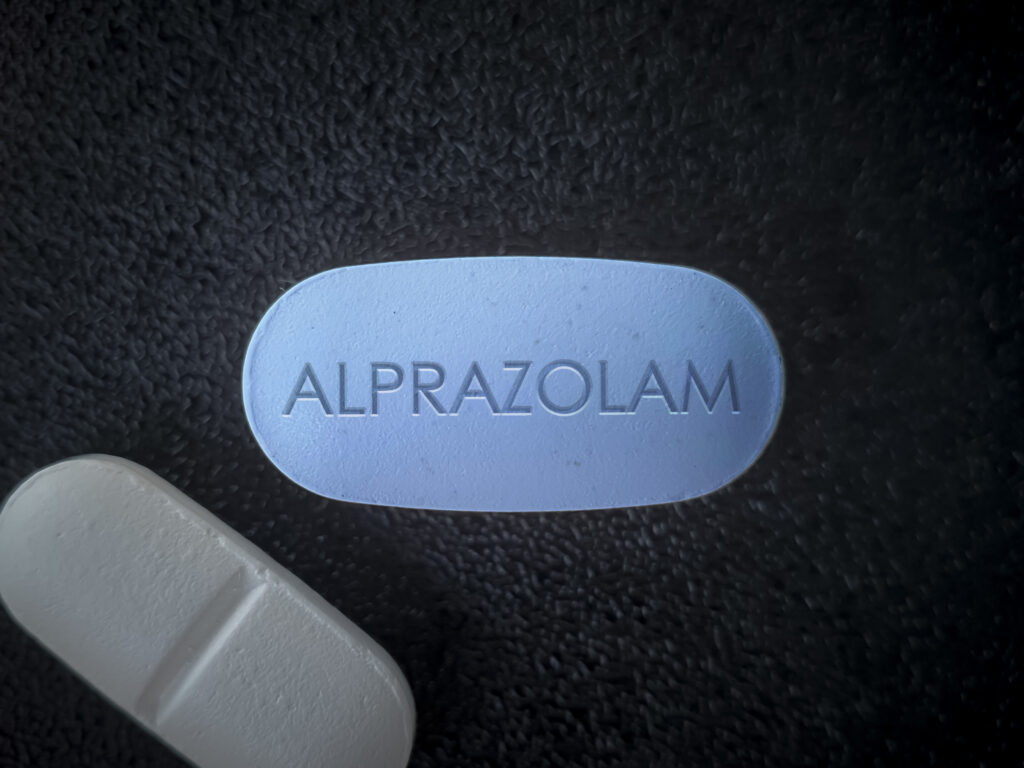 a pill with the word alprazolam, the generic name for Xanax
